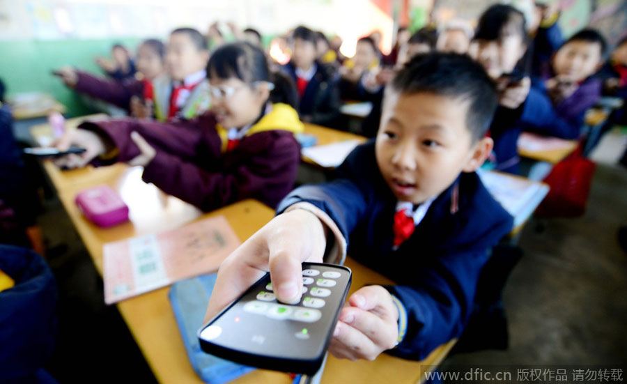 School children use responder device in class