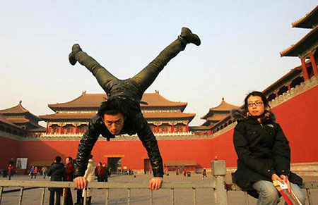 Du Yize, a young Chinese parkour fan, practices at a plaza in front of the Forbidden City in Beijing. [Photo: China Photo Press]