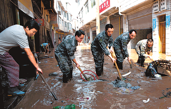 13 missing after landslide blankets village