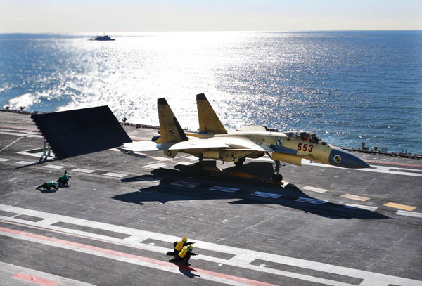 China conducts flight landing on aircraft carrier