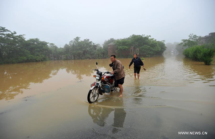 Road destroyed by rain-triggered floods in S China