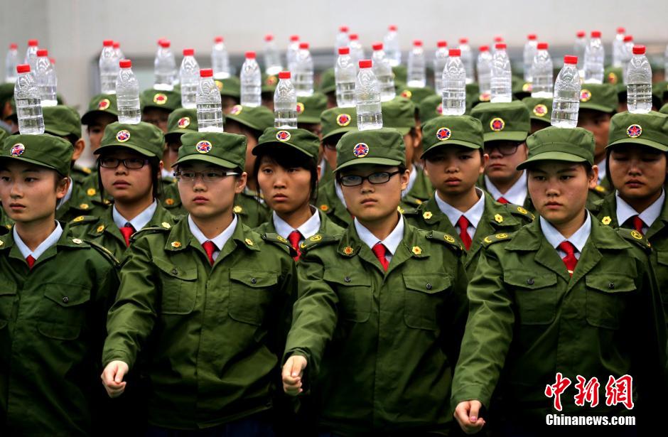 Military training with bottles balanced on heads