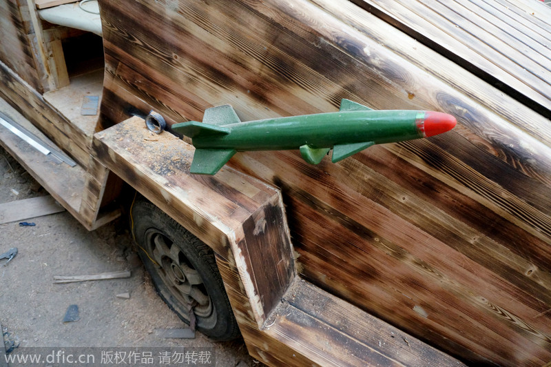 Carpenter carves armored vehicle from wood