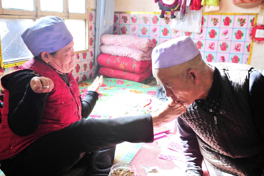 Disabled woman uses her feet to care for husband