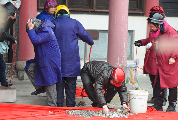 Throwing coins to please God of Wealth