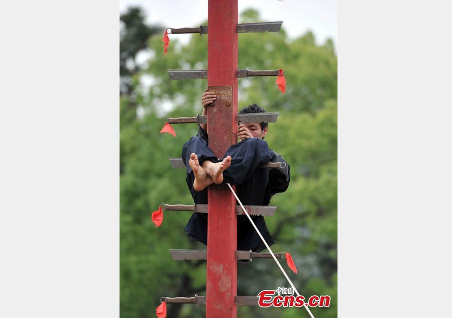 Climbing a ladder of knives to mark Double Third Day festival