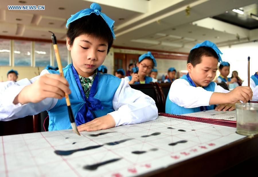 Children study calligraphy during summer class