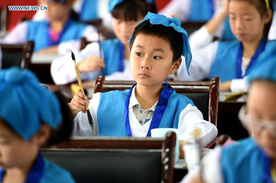 Children study calligraphy during summer class