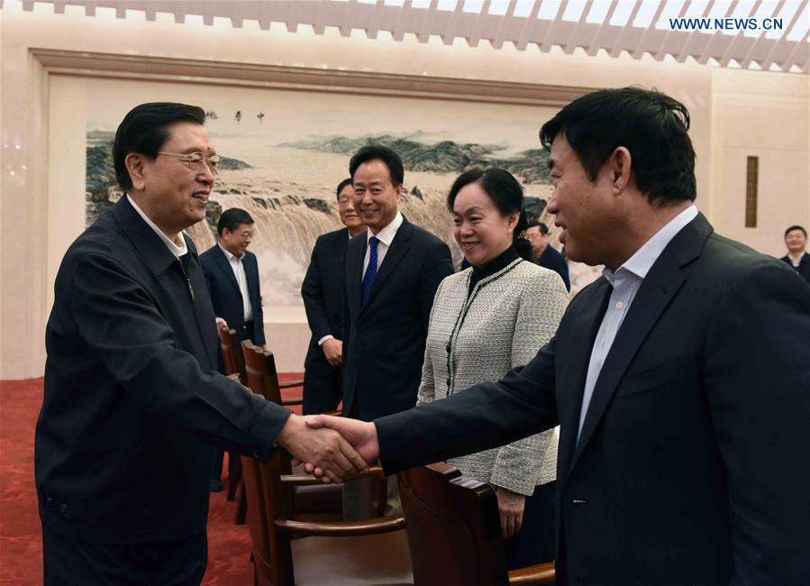 Top legislator presides over symposium on drafting NPC work report