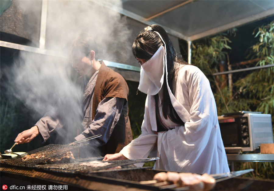 Restaurant employees serve history in traditional costumes