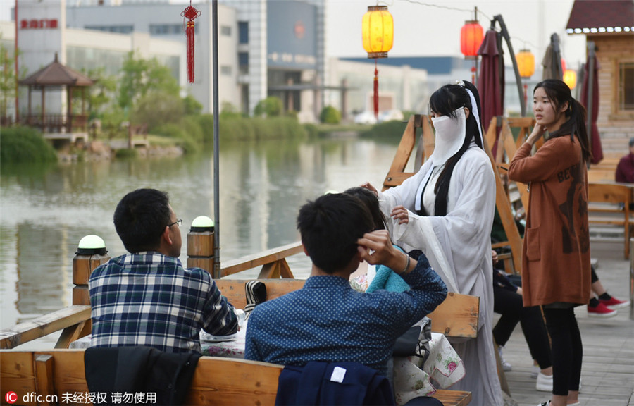 Restaurant employees serve history in traditional costumes