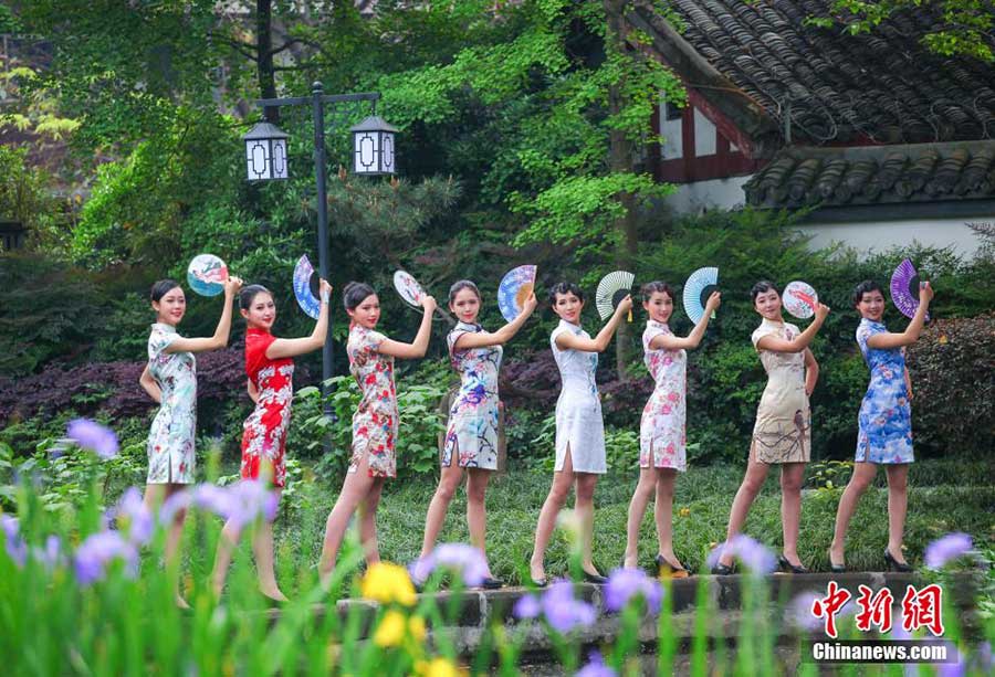 Stewardesses-to-be present traditional <EM>Qipao</EM> in SW China