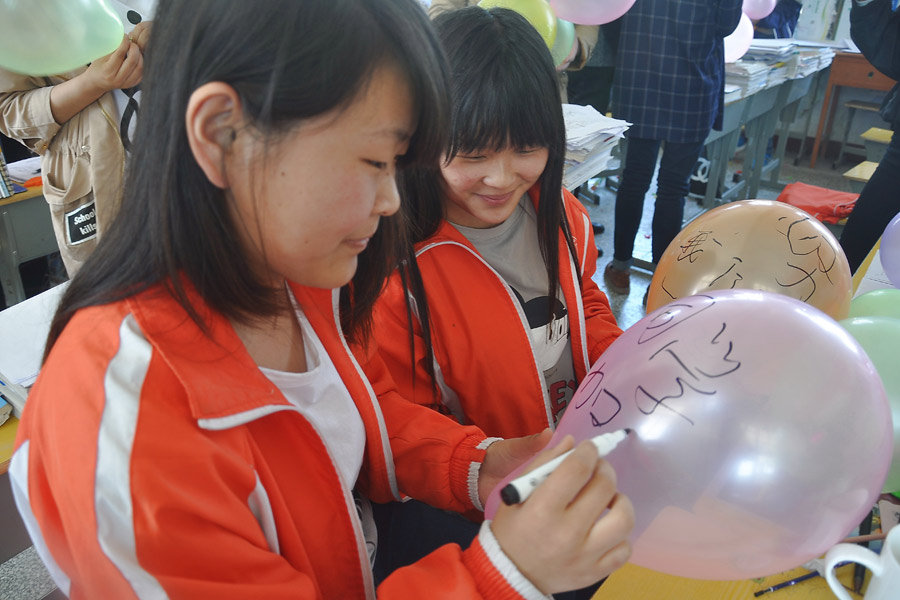 Balloons, paper planes and massages help students relax before college exam