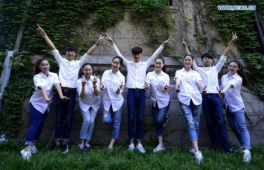 Students pose for graduation photo with performance