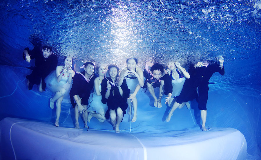 University students go underwater to celebrate graduation