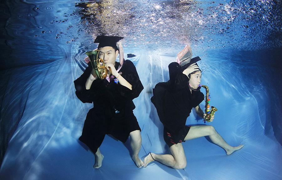 University students go underwater to celebrate graduation