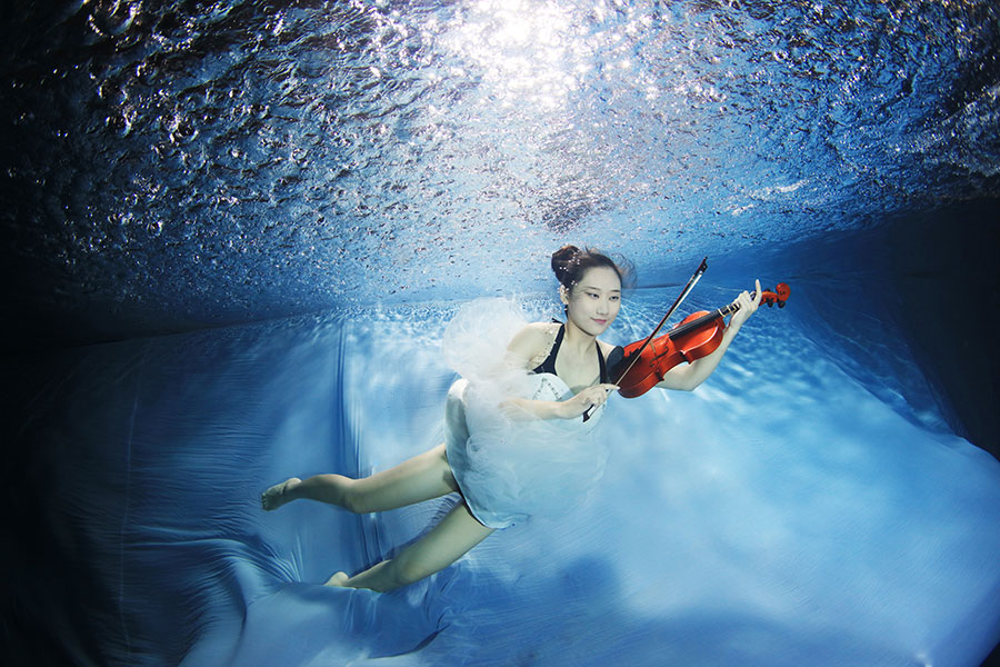 University students go underwater to celebrate graduation