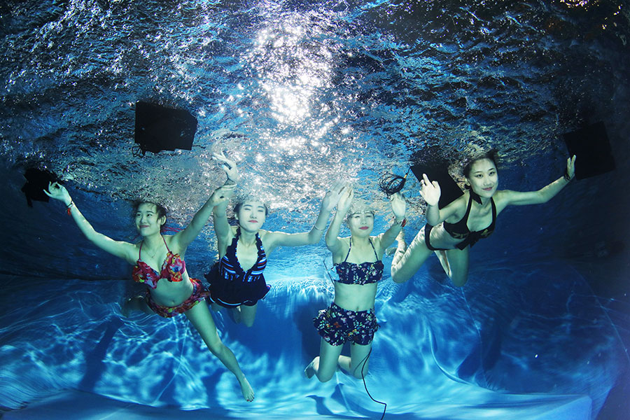 University students go underwater to celebrate graduation