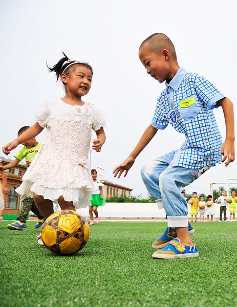 Kicking the ball: Kindergarten children play soccer