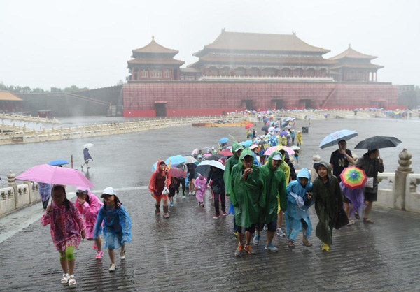 Beijing issues orange alert for heavy rain, train, flights delayed