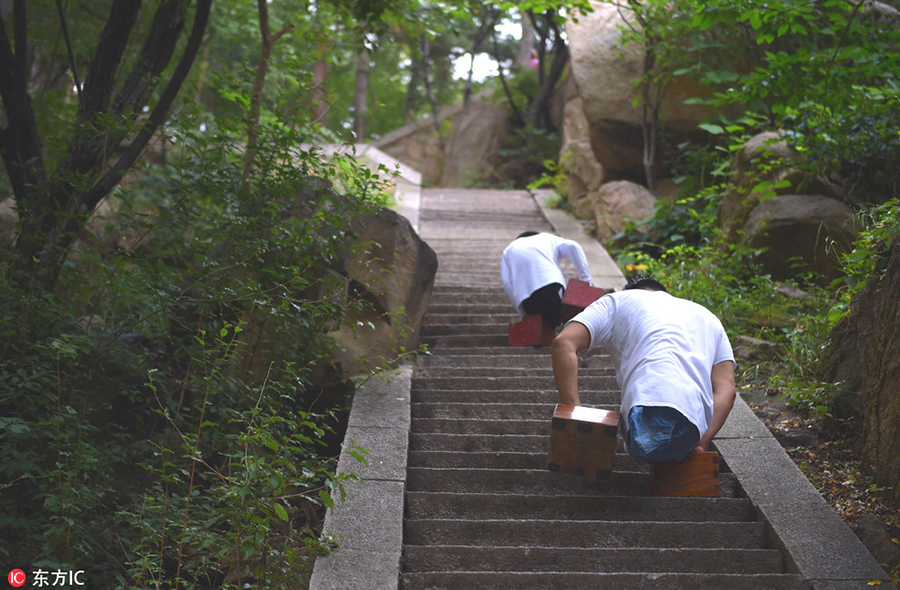 Legless man and boy climb a mountain together