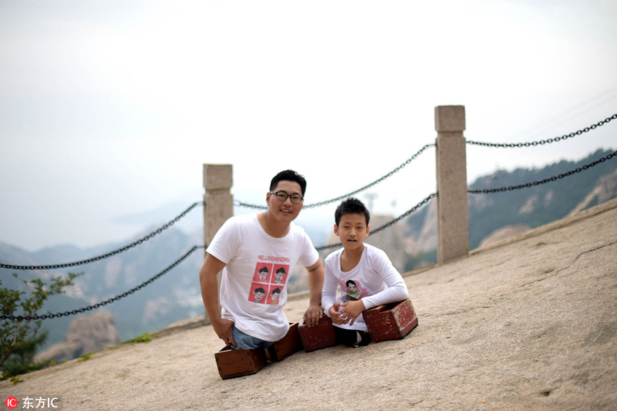 Legless man and boy climb a mountain together