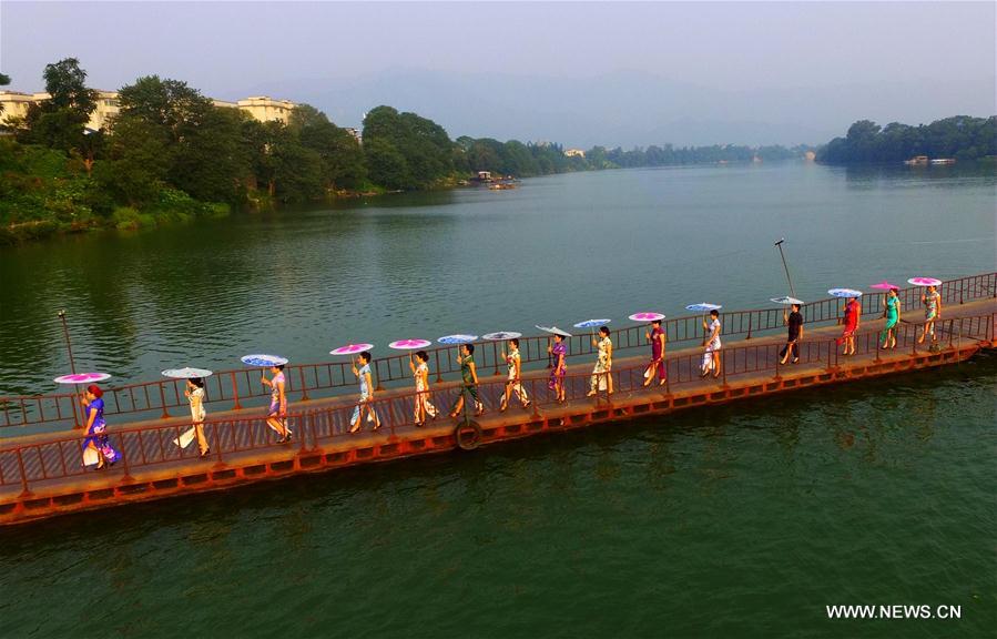 Ladies present <EM>qipao</EM> in South China's Guangxi