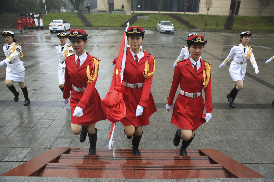 Marching in step: Female college students form flag-raising team