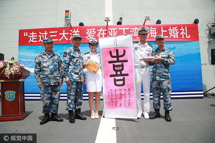 Navy sailors tie knot in middle of sea