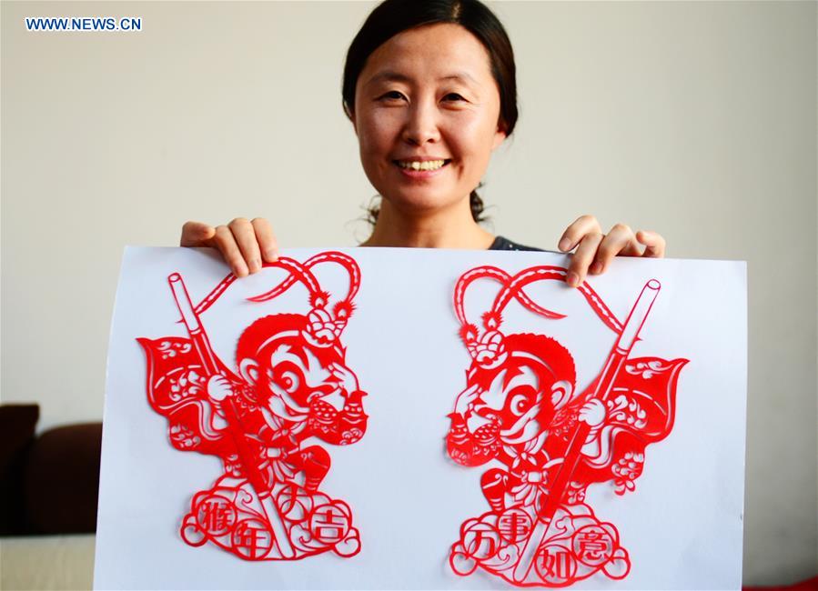 Folk paper-cutting artist shows her creations for Year of the Monkey