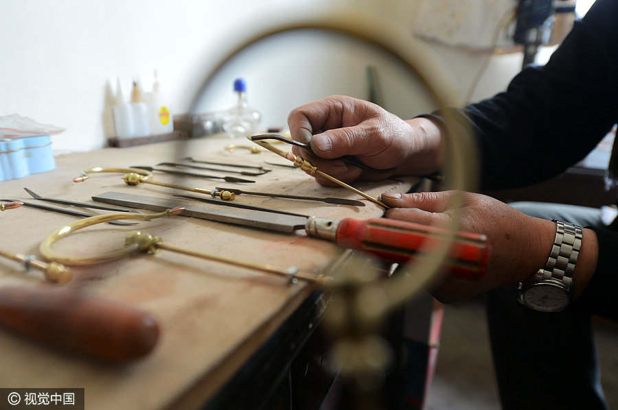 Folk artist dedicated to making bird cages