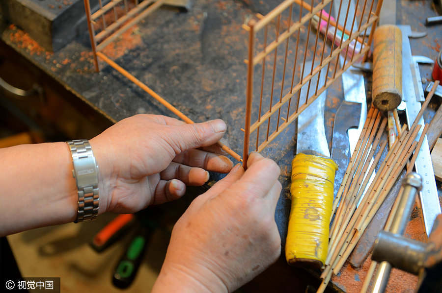 Folk artist dedicated to making bird cages