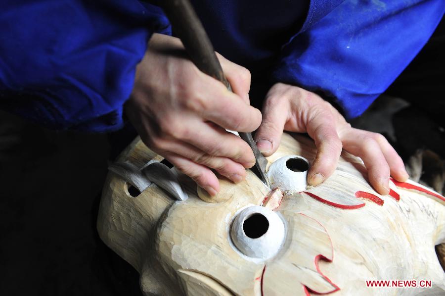 Folk artisan works on Nuo Opera masks