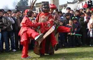 Folk artisan works on Nuo Opera masks