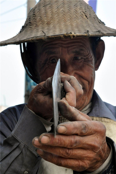 Man grinds knives for life