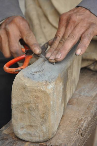 Man grinds knives for life