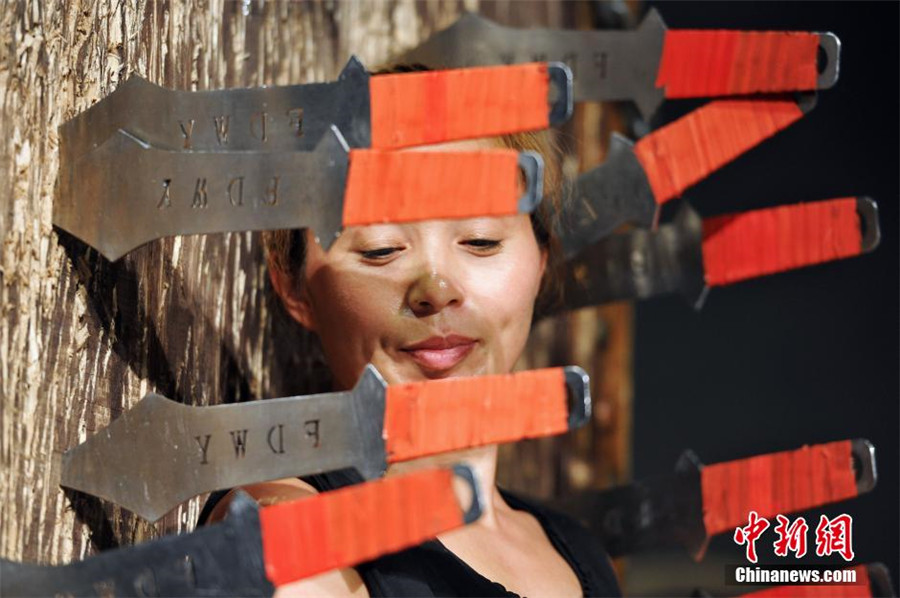 A folk artist couple famous for 'knives-throwing' performance