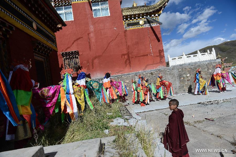 Monks wearing masks rehearse Gesar opera at Chalang Temple in NW China