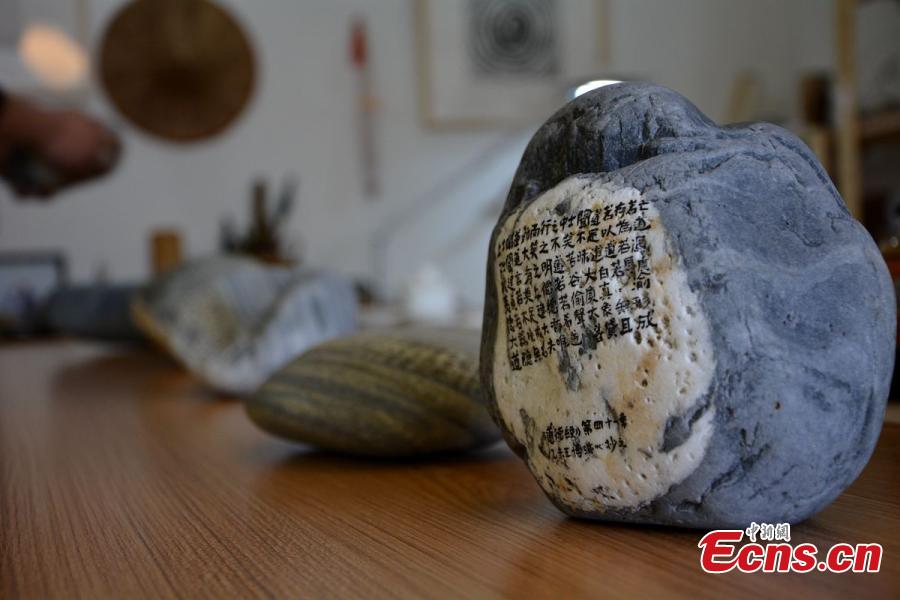 Calligrapher writes classic text on 81 stones