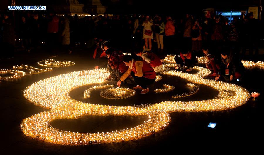 People pray for good luck at Guangren Temple in NW China