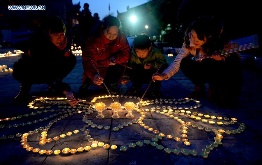 People pray for good luck at Guangren Temple in NW China