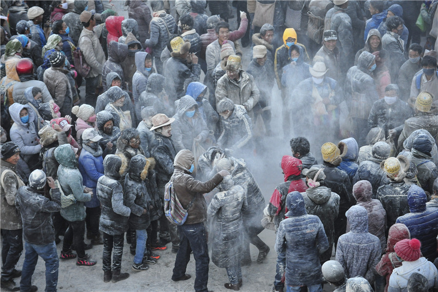 Tibetans spray zanba for new year blessings