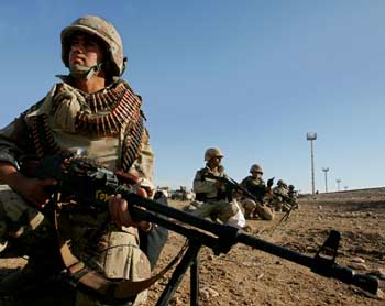 Iraqi troops with U.S. Marines prepare to move into the Sunni Muslim city of Falluja, November 9, 2004. Thousands of U.S. and Iraqi troops backed by heavy air support and armour have stormed into the Sunni Muslim city of Falluja on Tuesday in the second major offensive in seven months to try to recapture the insurgent stronghold. The picture is from embedded photographer accompanying U.S. military. [Reuters]