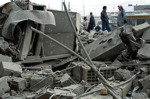 Residents search trough the rubble of a building destroyed during an airstrike the previous day in the northern Iraqi city of Mosul, Thursday, Dec. 30, 2004. U.S. troops and warplanes killed at least 25 insurgents as they attacked an American outpost Thursday in northern Iraq with a car bomb and explosives. (AP Photo/Str)