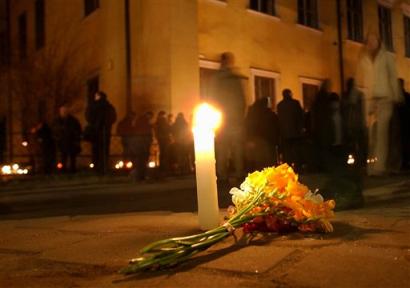 A burning candle and flowers are placed in front of the bishop's residence in Krakow, southern Poland on Sunday, April 3, 2005, the day after the Vatican announced the death of Pope John Paul II. Pope John Paul II served as priest and bishop in Krakow. (AP Photo/Czarek Sokolowski) 