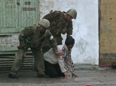 Uzbek soldiers 
 search a local resident at the square outside the administration building in downtown Andijan, Uzbekistan, Friday, May 13, 2005. [AP]