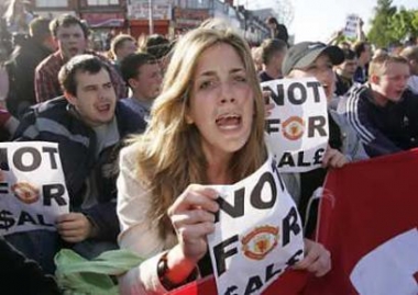 Supporters protest outside Manchester United's Old Trafford stadium in Manchester, north west England May 12, 2005. U.S. tycoon Malcolm Glazer finally seized control of Manchester United after a drawn-out and bitter battle, buying out its biggest investor and amassing a 70 percent stake in the world's richest soccer club in a deal valuing it at 790 million pounds ($1.5 billion). Fans' groups called a demonstration at the Old Trafford ground, saying Glazer had no knowledge of the football side of the club and was only interested in its brand and revenue. (Ian Hodgson/Reuters)