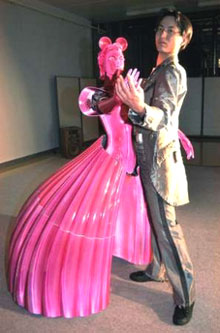 A robot dance partner, MS DanceR, (L) dances with the lead of a man in Chino, central Japan, June 4, 2005. MS DanceR was manufactured by Nomura Unison Co Ltd and Tohoku University.