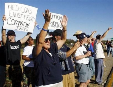 Anti-war protester Linda Foley, center, cheers as fellow protesters are released from the McLennan County Jail, Wednesday, Nov. 23, 2005, in Waco, Texas.