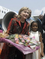 Clinton seeks better ties with oil giant Angola